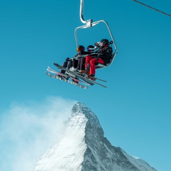 Skiers on a chairlift above the Matterhorn in Switzerland, representing Swiss family offices and alpine wealth management hub