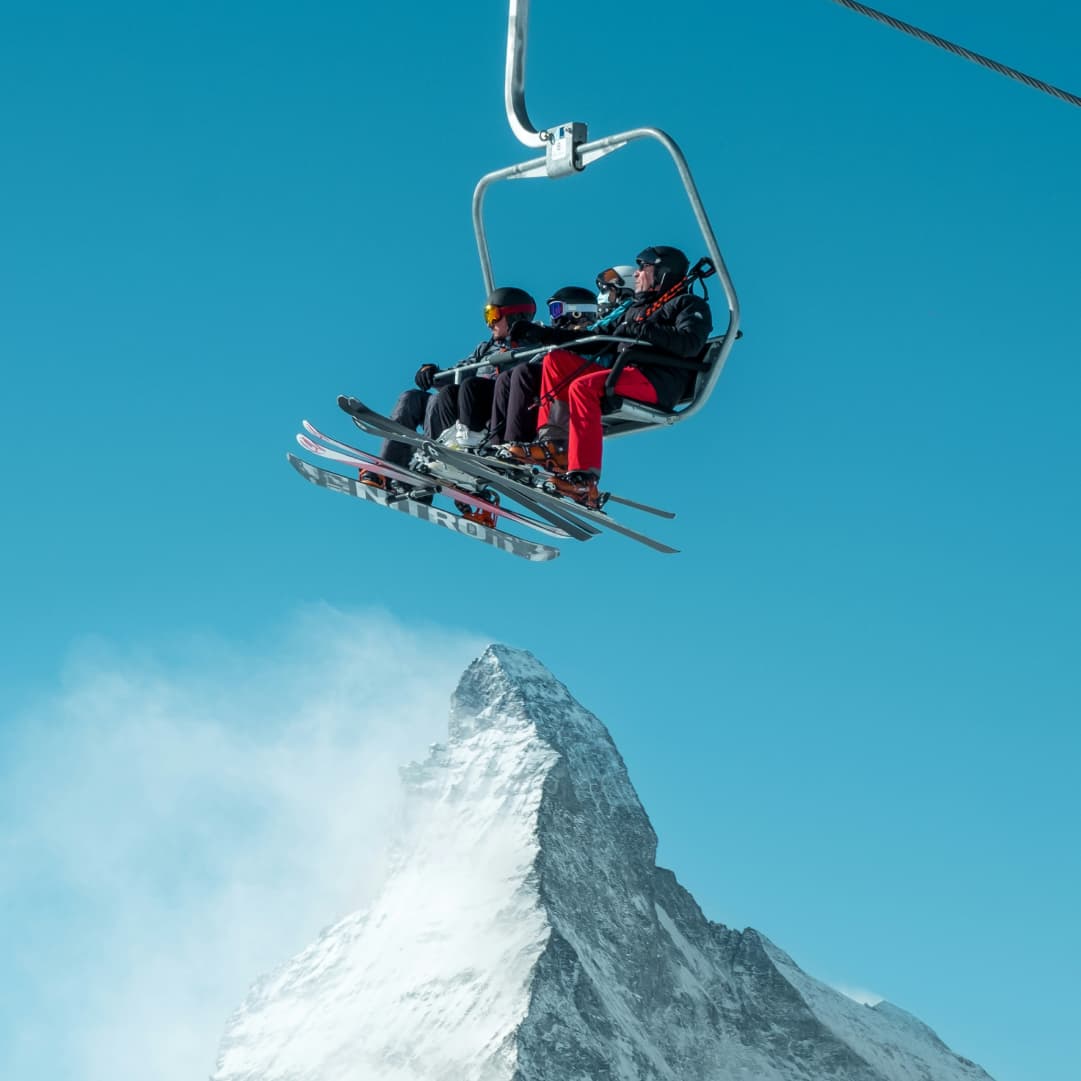 Skiers on a chairlift above the Matterhorn in Switzerland, representing Swiss family offices and alpine wealth management hub