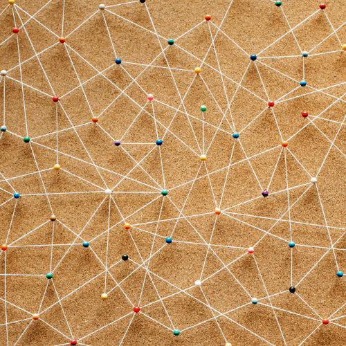 Network of coloured pins connected by white strings symbolising integration and automation in family office systems