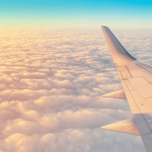 Private jet wing above clouds at sunset illustrating Maison Benjamin’s high-level family office concierge and crisis management services