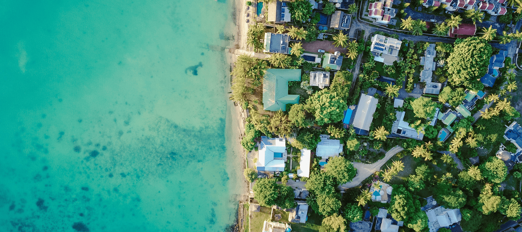 Aerial view of luxury homes along the Mauritius coastline, illustrating the island’s growing appeal as a hub for family offices and international wealth management.
